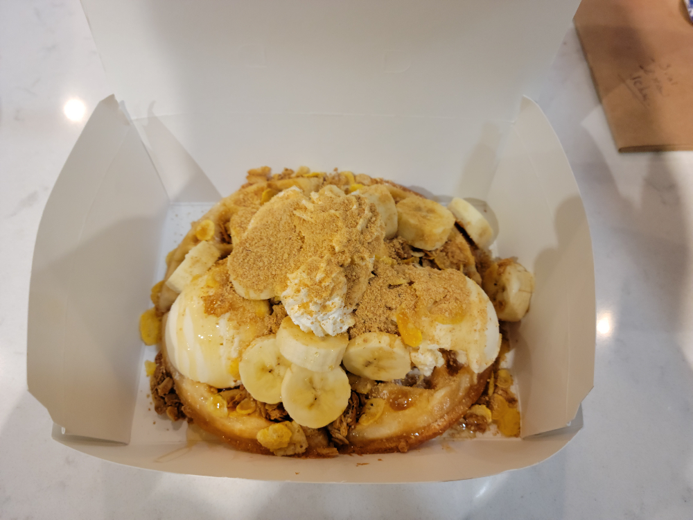 A Heavy Banana Cream on a waffle inside of a paper takeout container. Photo by Matthew Macomber.