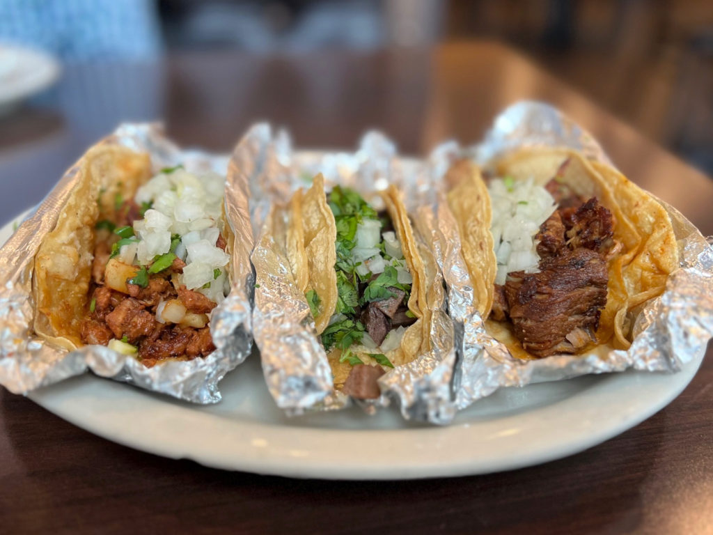Three tacos from El Rancho Grande II in Savoy: al pastor, lengua, and carnitas. Photo by Alyssa Buckley.