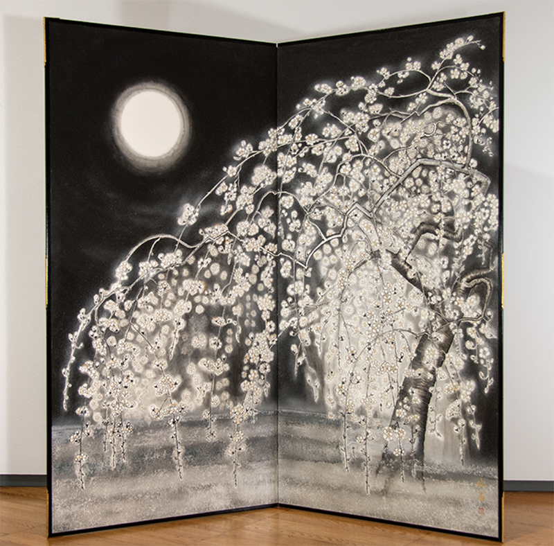 Photo of two-panel screen featuring an ink wash drawing of a cherry blossom tree against a black sky light with a full white moon.