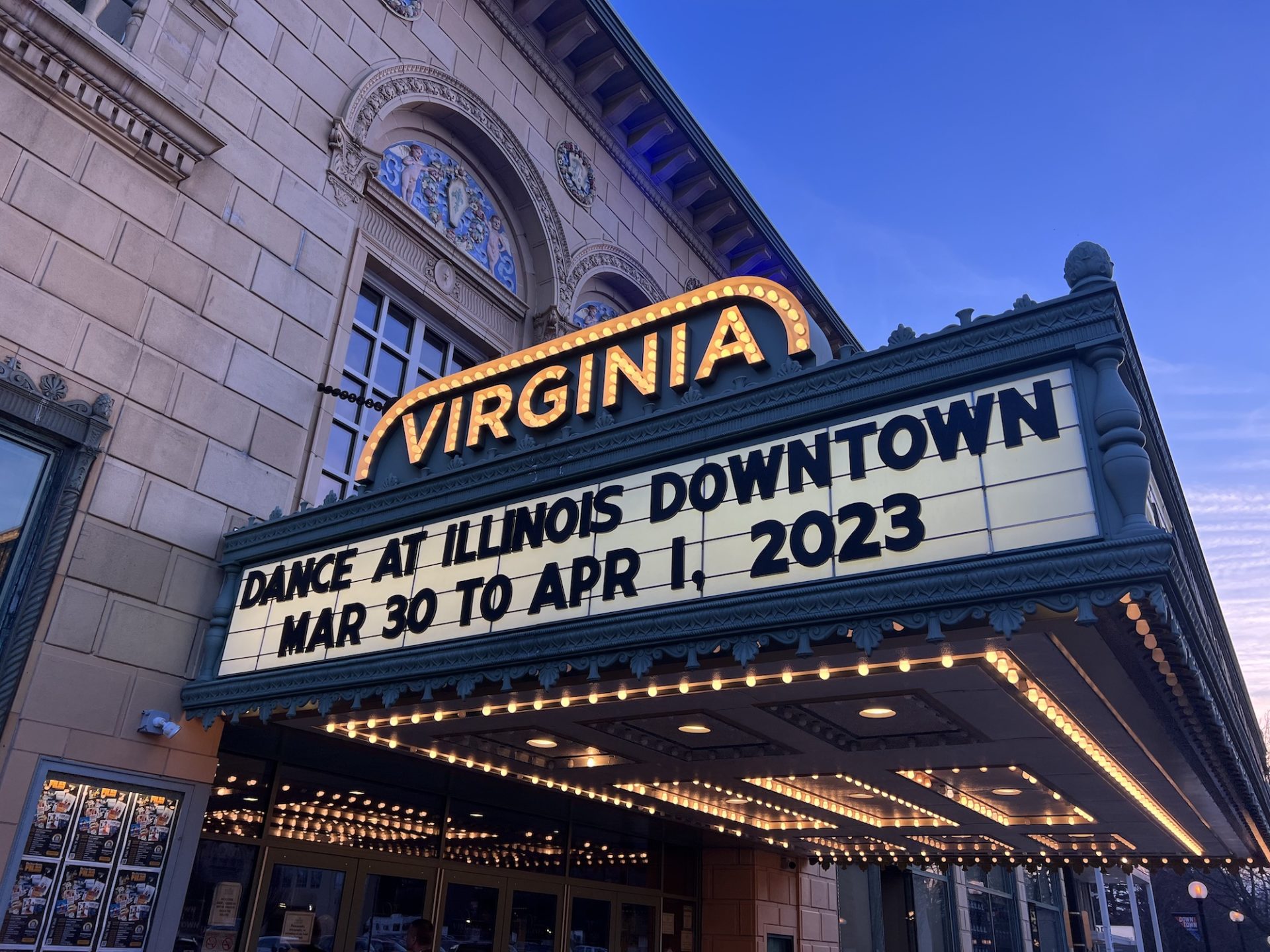 A nighttime view of the Virginia Theatre marquee announcing the Dance at Illinois Downtown show.