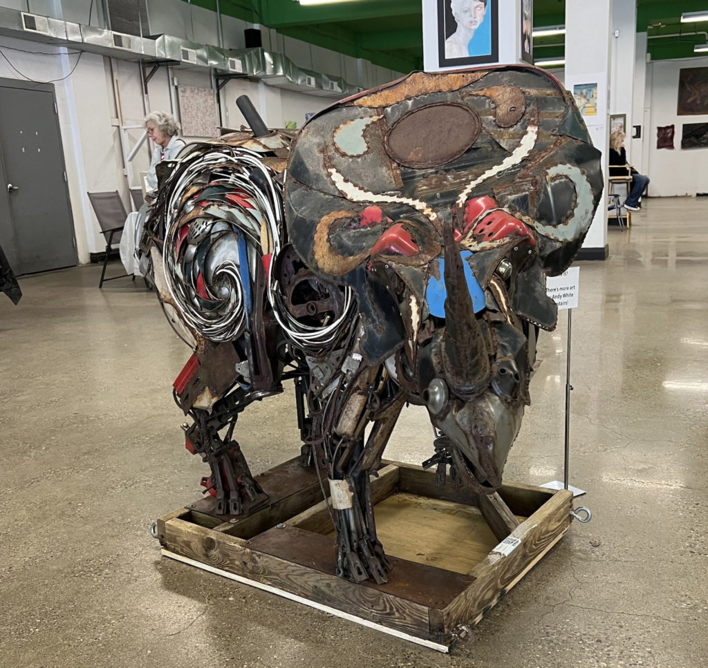 A metal sculpture of a rhinoceros by Andy White