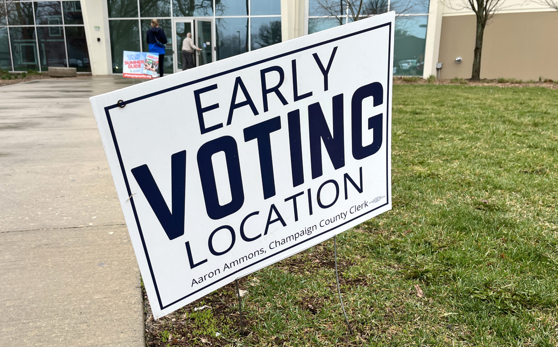 A white yard sign that says "early voting location" in dark blue is in front of the Leonhard Rec Center in Champaign.