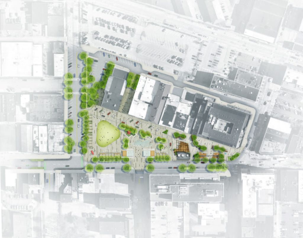 A rendering of a park plaza. Much of the image is gray and white, but the portion indicating the plans are in color, featuring a triangle of green space.