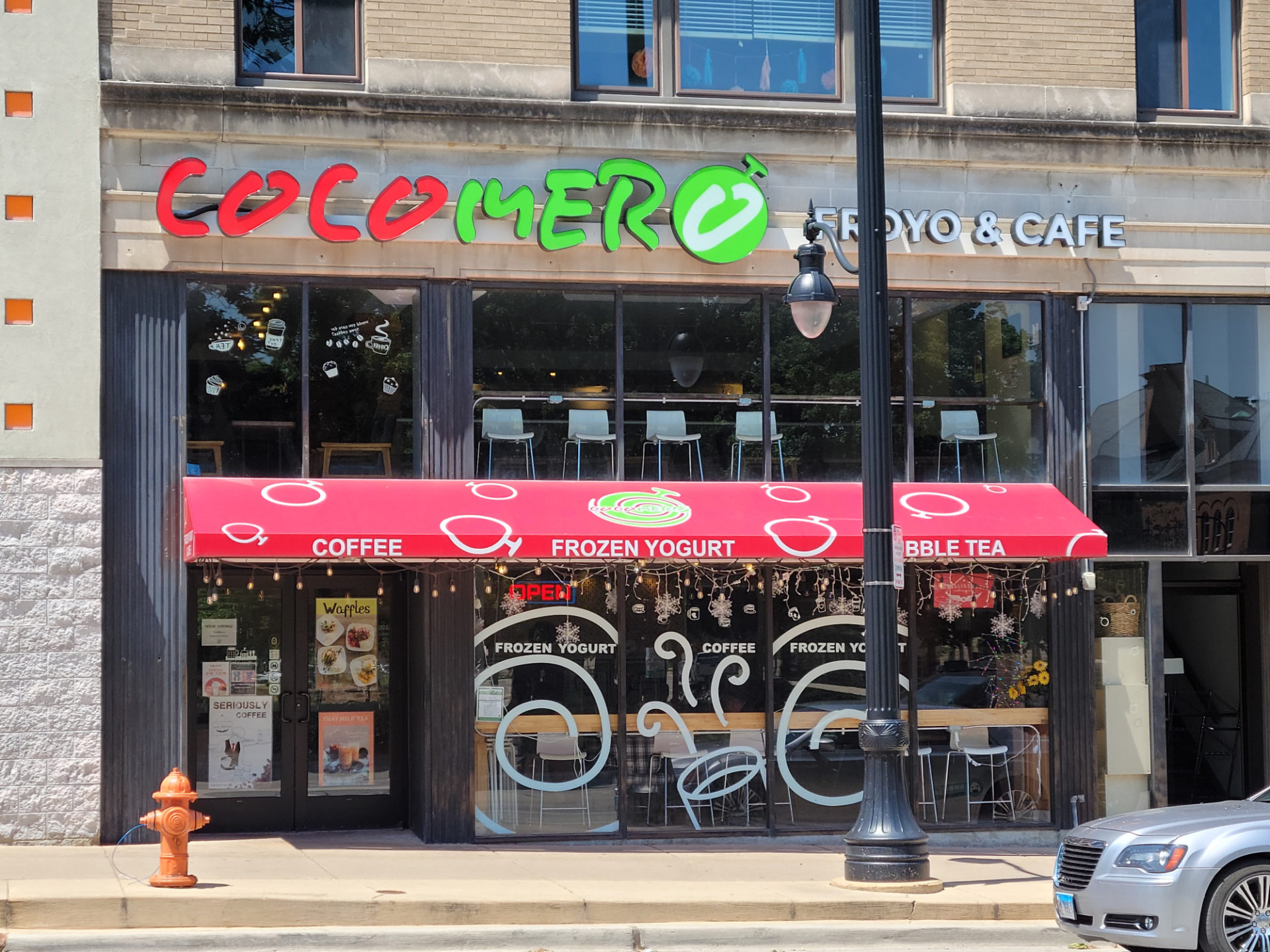 The exterior of Cocomero with two pulling glass doors. Photo by Matthew Macomber
