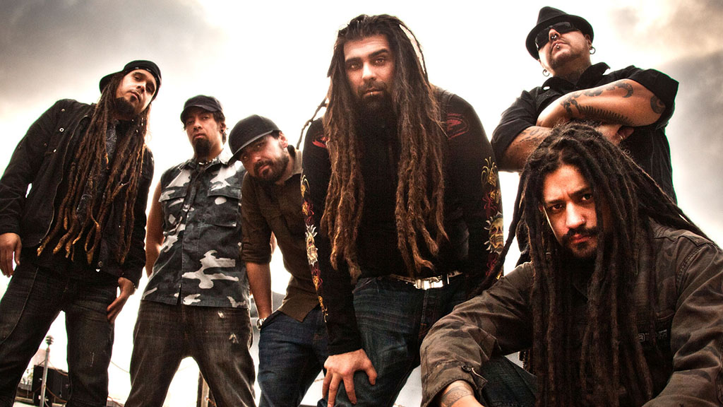 Six Members of Ill Nino in various poses all looking at the camera