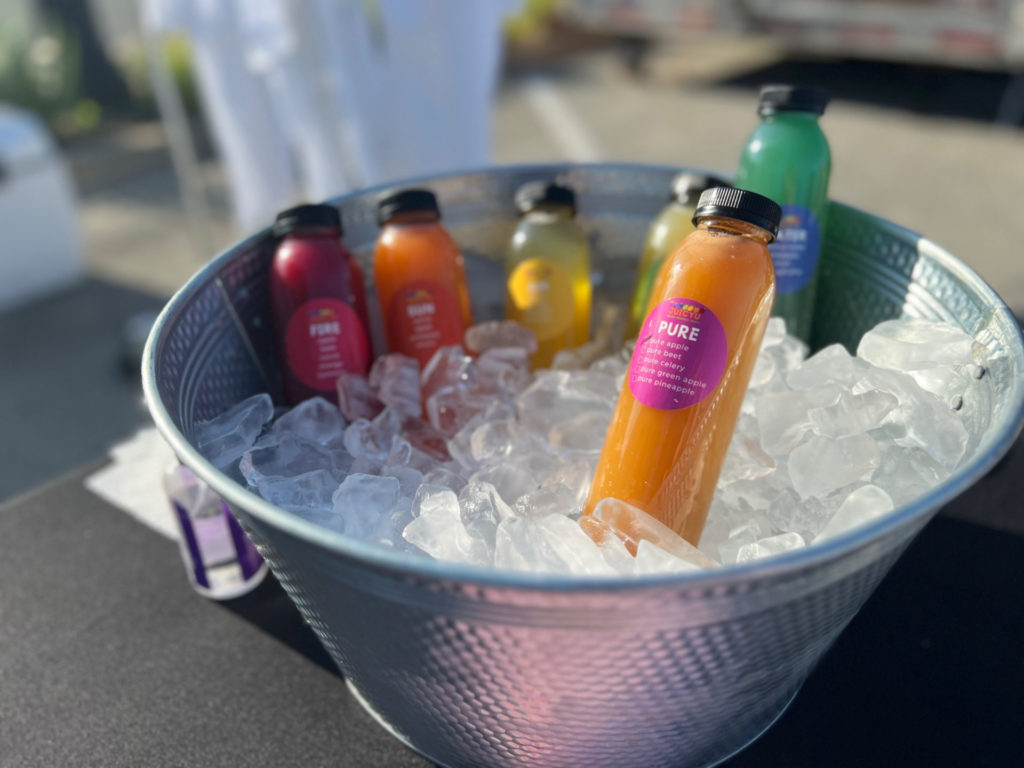 JuicyU juices in a metal basin filled with ice at the Urbana farmers' market. Photo by Alyssa Buckley.