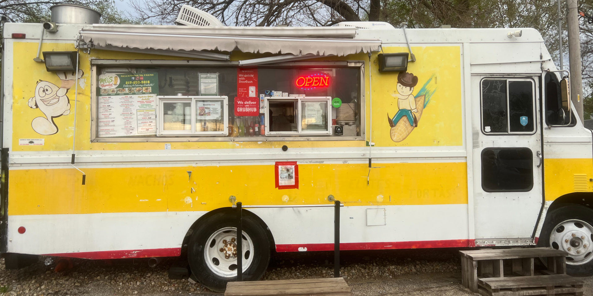 The yellow taco truck Mo's Burritos which is permanently parked at the corner of Prospect Avenue and Bradley Avenue in Champaign. Illinois. Photo by Grace Kang.
