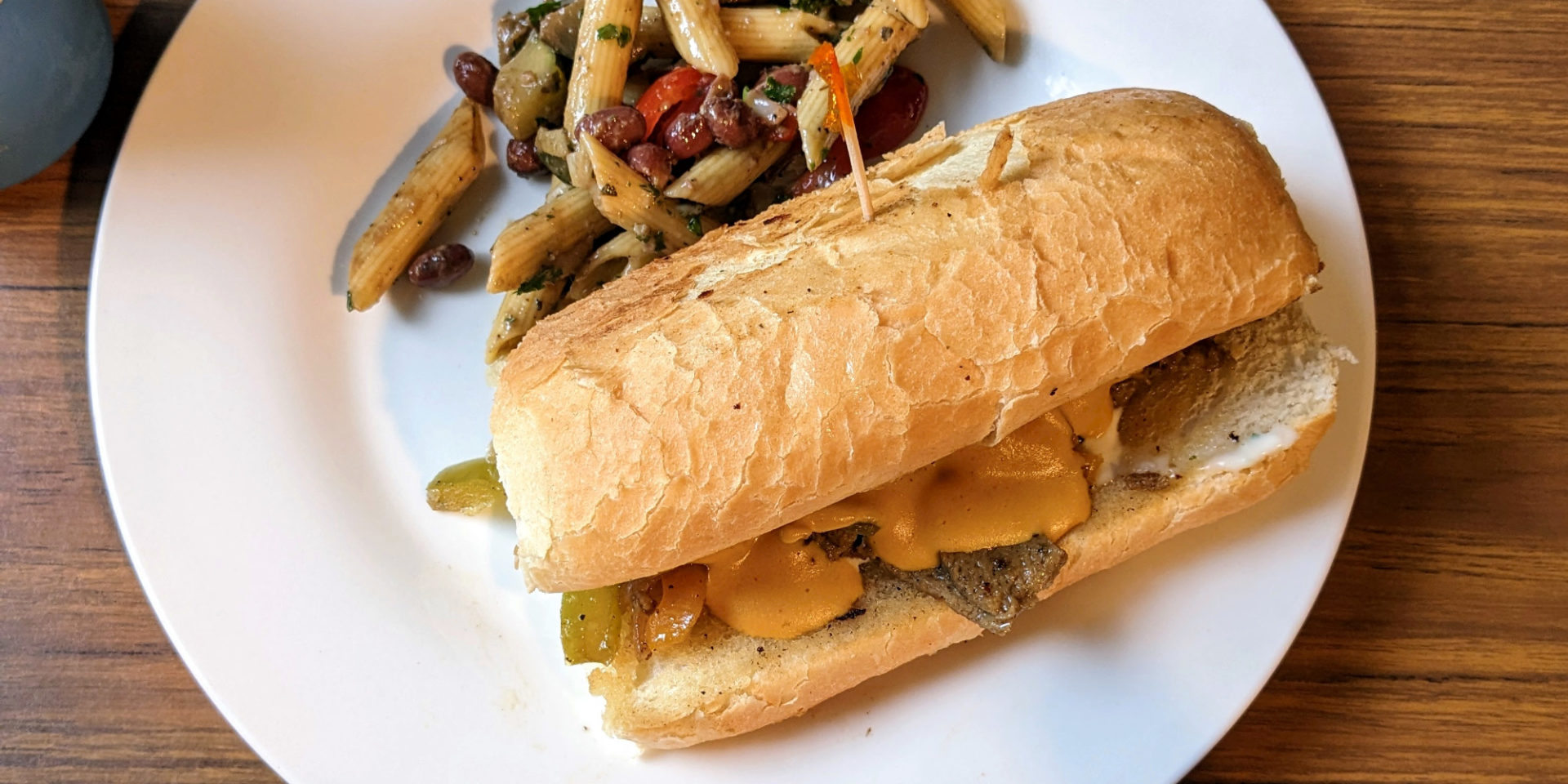 A cropped image of a Philly cheezesteak on a white plate at Red Herring Vegetarian Restaurant. Photo by Caitlin Aylmer.