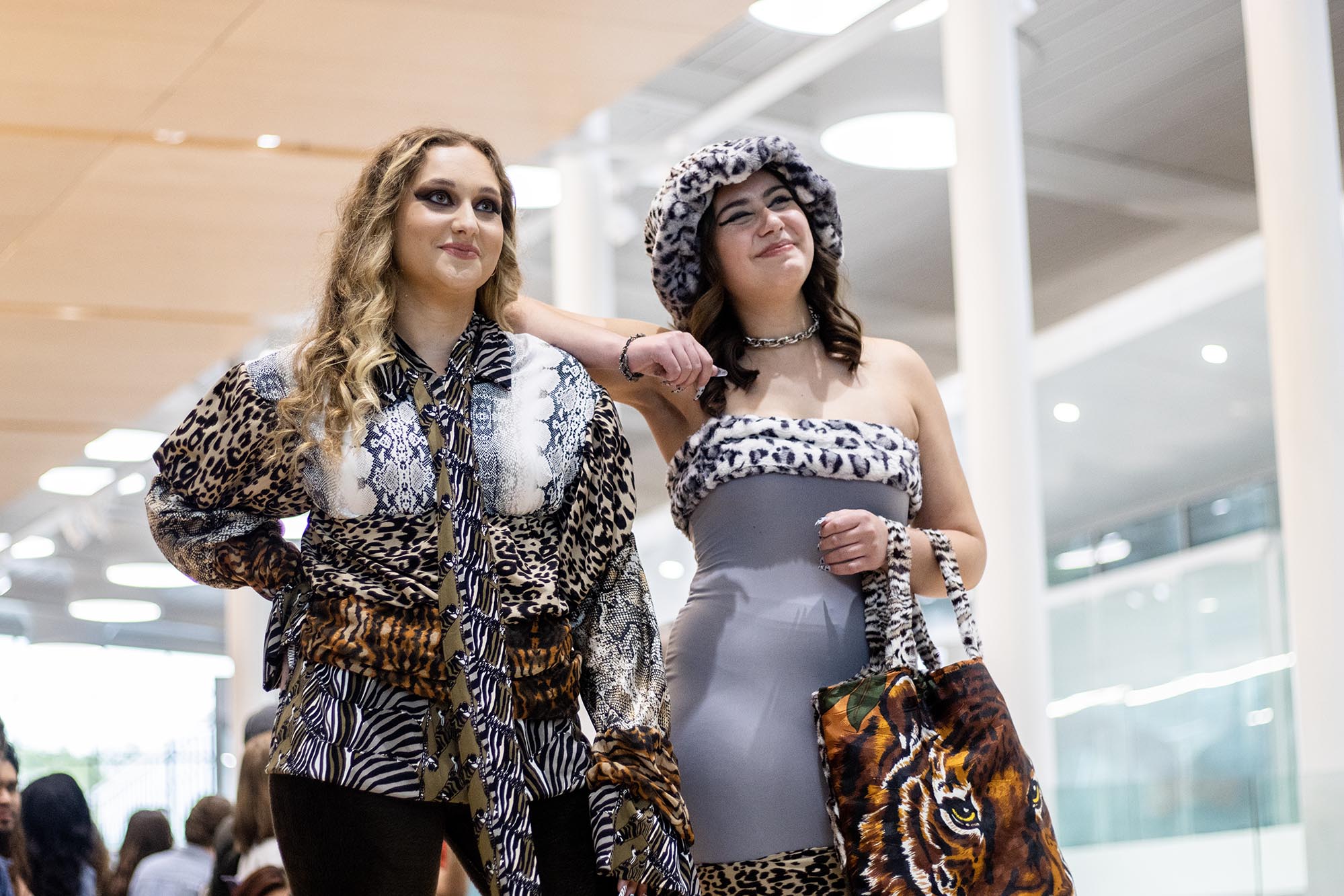 Re-Fashioned 2023. Two female models wear outfits that incorporate all different kind of animal prints.