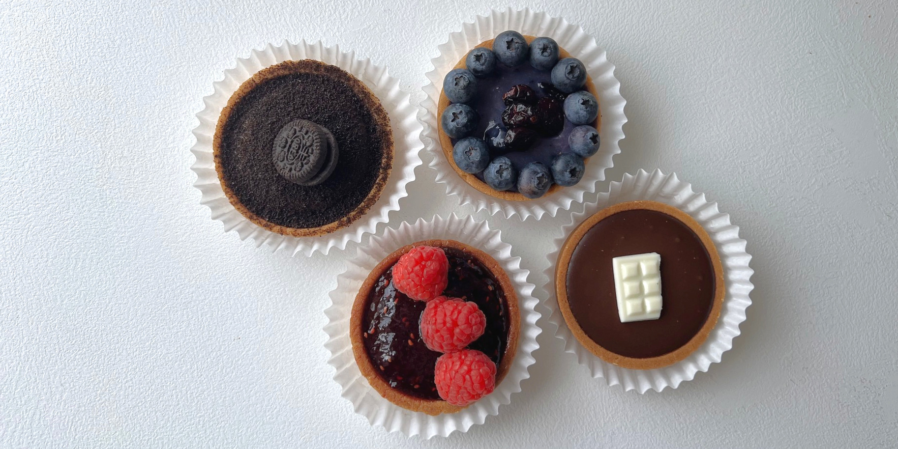 Four chocolate tarts from Tasty Tart in Champaign, Illinois. Starting in the top left: Oreo, blueberry white chocolate, chocolate, and raspberry chocolate. Photo by Alyssa Buckley.