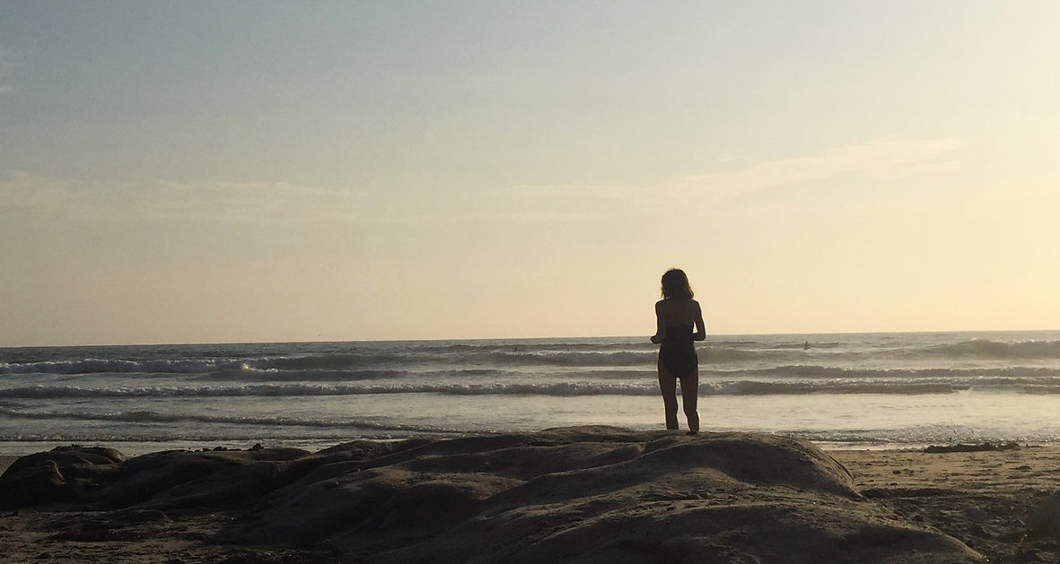 A woman standing on a beach