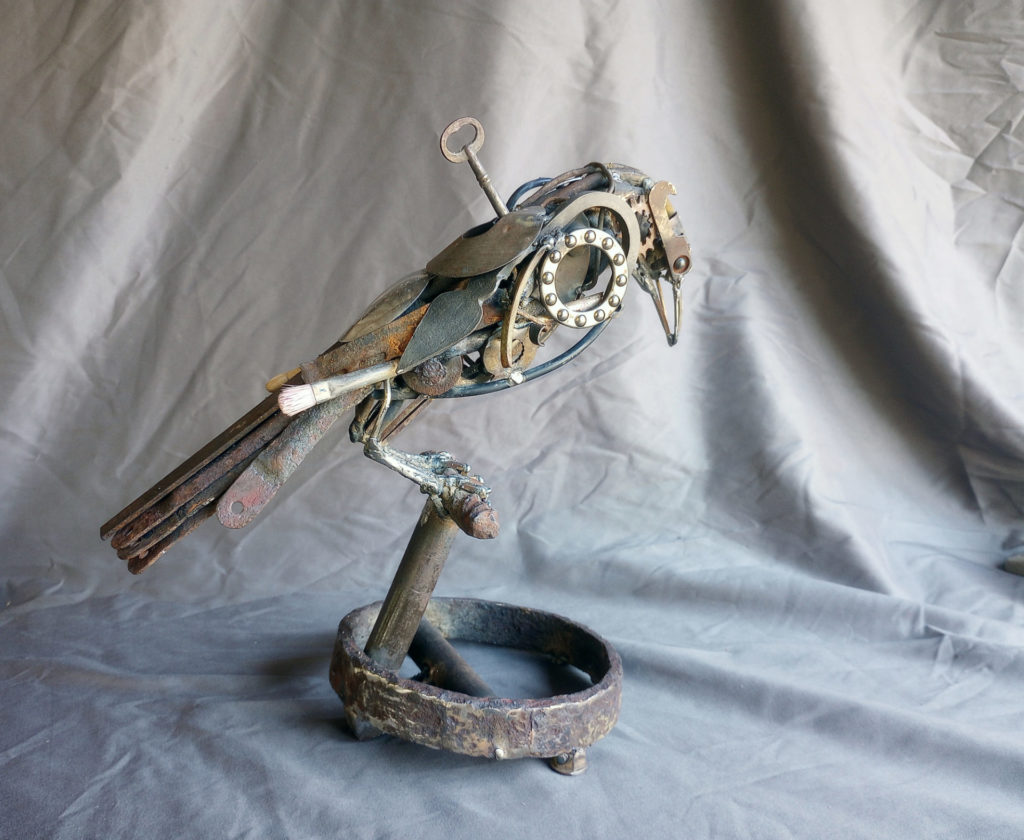 Metal sculpture by Andy White of a bird. 