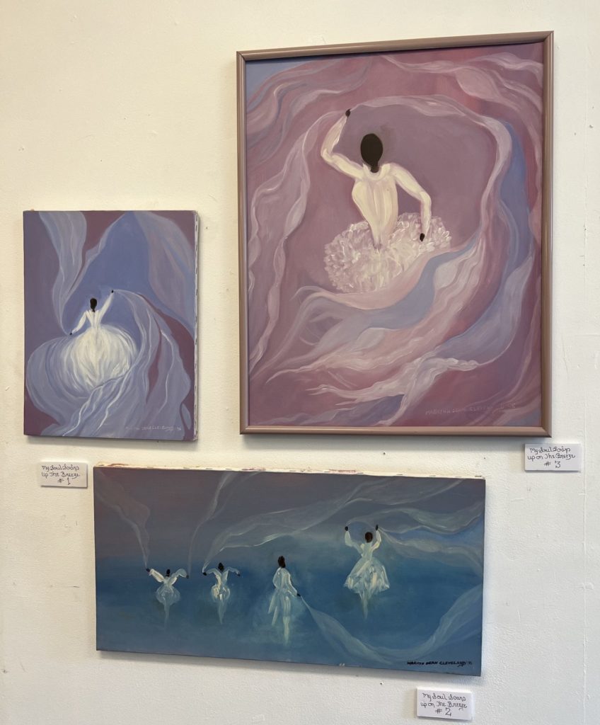 Three paintings by Marilyn Dean Cleveland. The top left is the smallest, a square, primarily blue. Right top is primarily pink and a vertical rectangle, bottom center is primarily turquoise and a wide rectangle. Each feature black ballerinas with white swirls surrounding them.