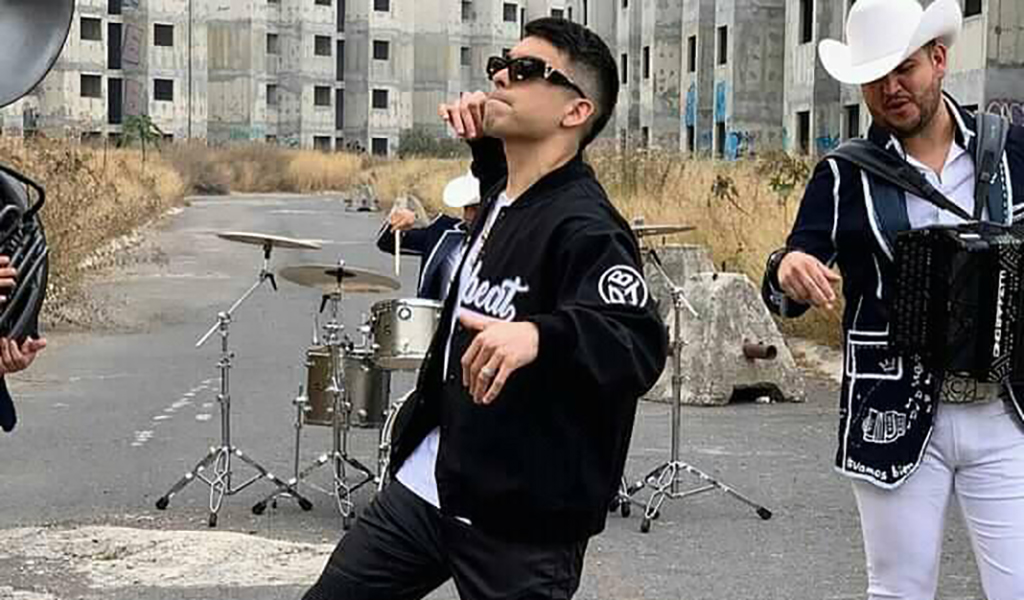 A rapper named MC Davo dancing on a street where he and his band are playing