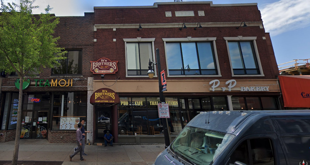 A street view of Brother's Bar in Champaign, a brick building with a sign