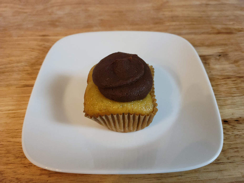 A banana pawpaw mini cake with a cupcake wrapper on a small plate. Photo by Matthew Macomber.
