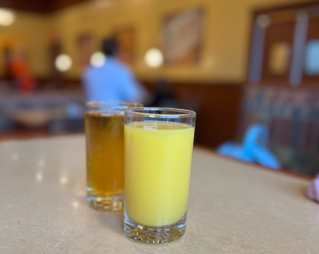 Two glasses of juice on a booth table in Champaign. Photo by Rashmi Tenneti.