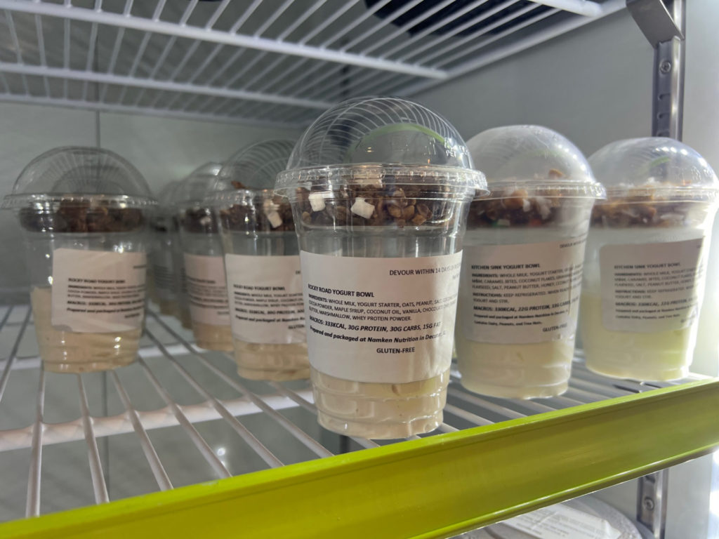 Many yogurt bowls by Namken Nutrition are lined up inside a cooler. Photo by Alyssa Buckley.