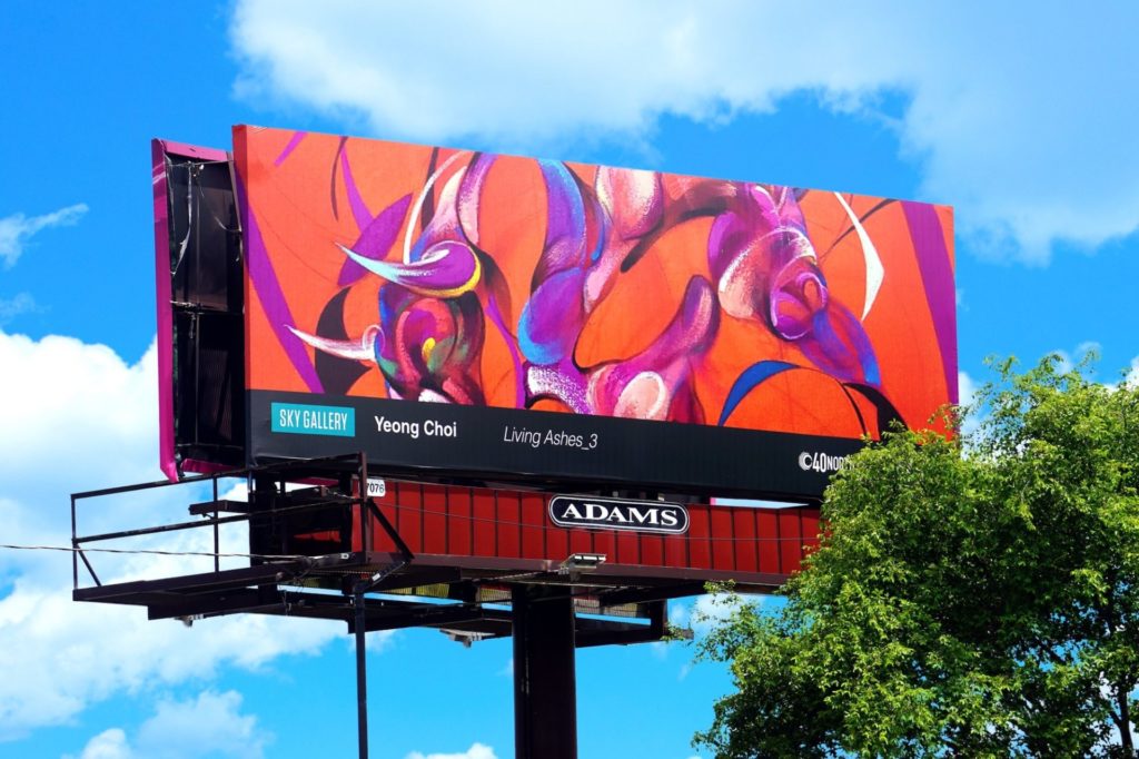 A billboard against a bright blue sky. A close up almost abstract image of a bull. The painting is mostly red, coral, and purple. The bottom reads "Sky Gallery, Yeong Choi, Living Ashes_3"