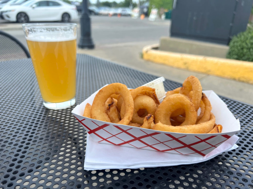 For summer eats in Champaign-Urbana, a pint of beer and a basket of onion rings at Bunny's Tavern. Photo by Alyssa Buckley