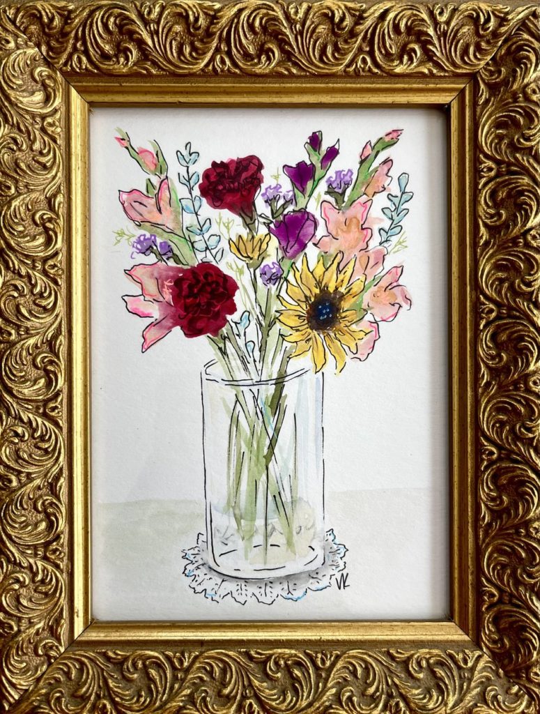 A still-life watercolor painting of flowers in a vase, framed in a thick ornate gold frame