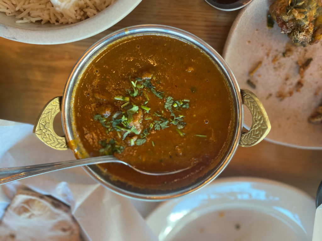 An overhead photo of the goat curry. Photo by Ayesha Mehta.