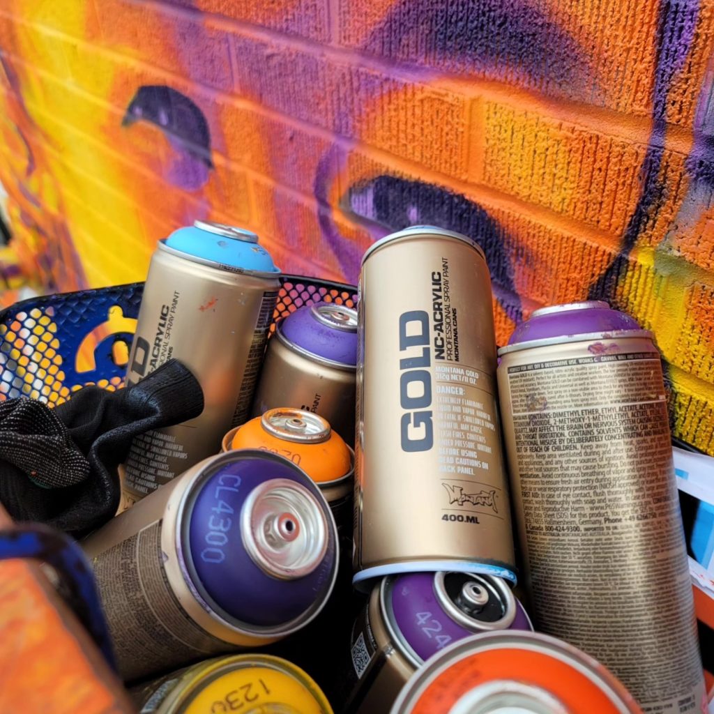 A close up shot of a bunch of spray paint cans