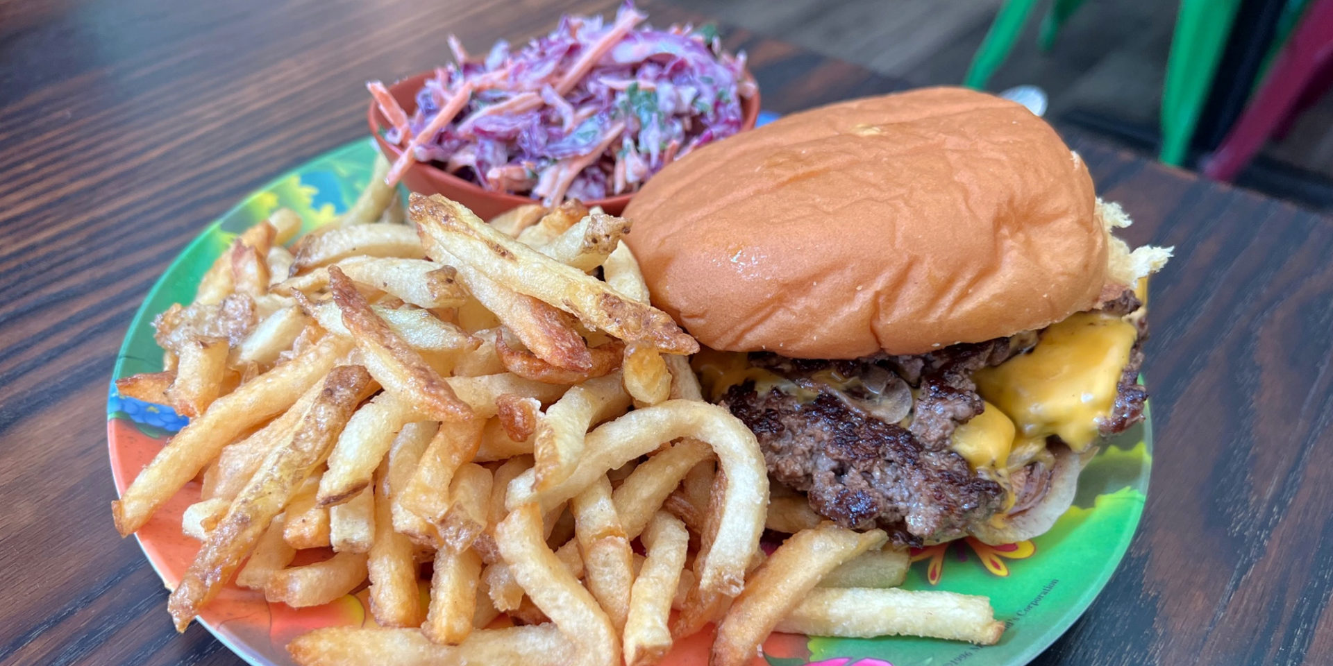 A delicious burger and fries with a side of purple coleslaw is on an old McDonalds plate in Champaign, Illinois. Photo by Alyssa Buckley.