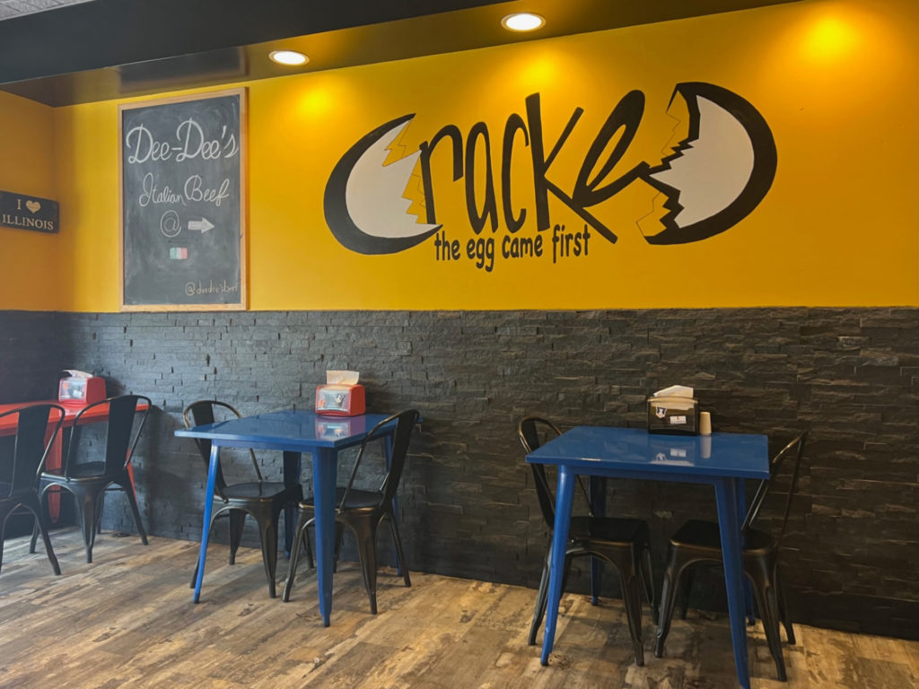 Inside Cracked on Green Street in Champaign, there is a pop-up restaurant called Dee-Dee's Italian Beef, written on a black chalkboard on the bright yellow wall. Photo by Alyssa Buckley.