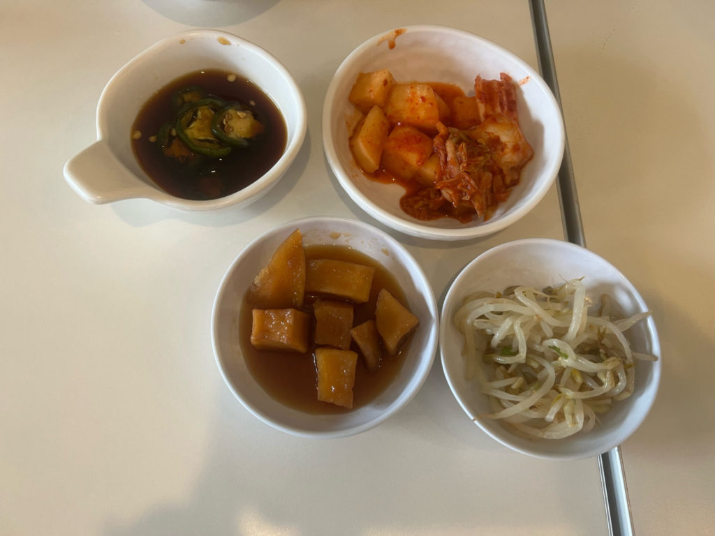 Korean banchan side dishes that are on the house with your meal. Photo by Grace Kang.