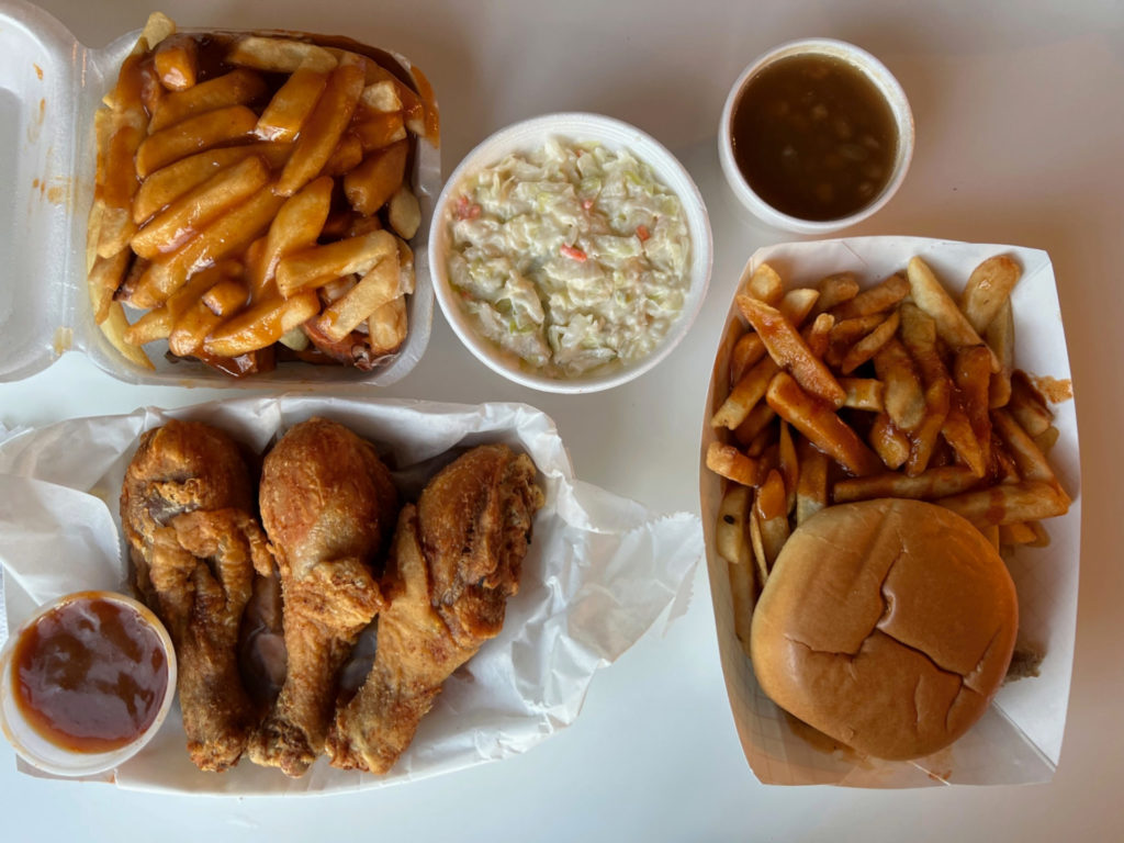 An overhead photo of saucy fries in Champaign-Urbana by Wood N Hog Barbecue restaurant. Photo by Alyssa Buckley.