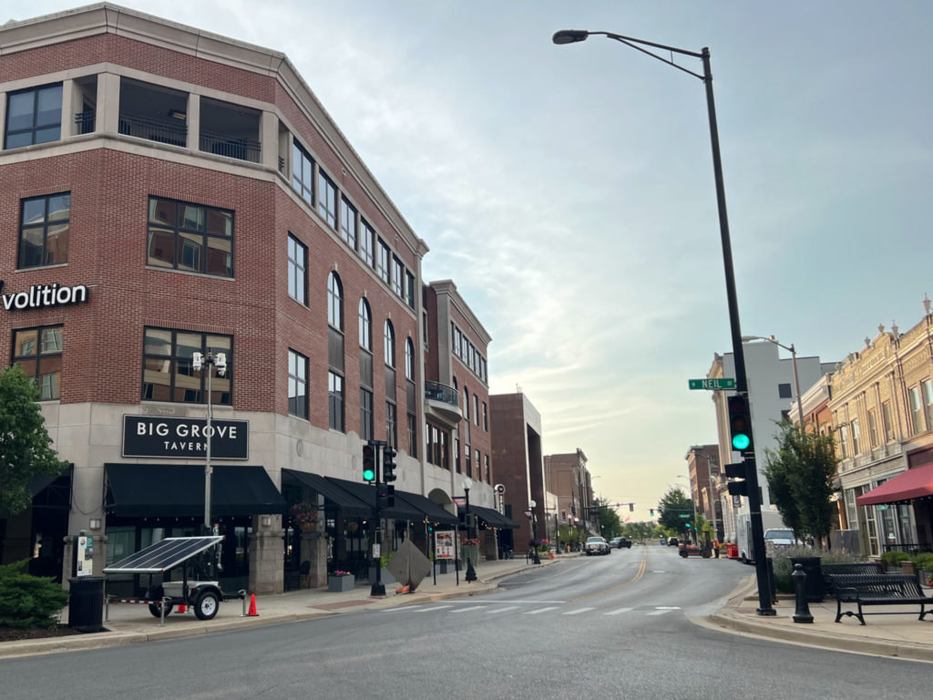 1 East Main Street in 2023 has Big Grove Tavern, Volition, and a paved street with lamps and traffic lights. Photo by Alyssa Buckley.