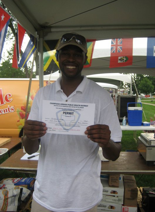 In 2010, Mike Harden holds a health permit to serve food at Taste of C-U. Photo courtesy of Caribbean Grill.