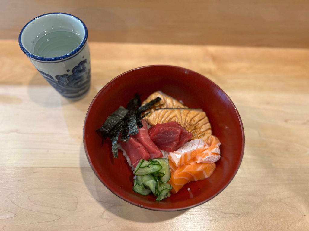 An overhead photo of ISHI's new lunch menu with sushi bowls of raw tuna and salmon over rice. Photo by Alyssa Buckley.