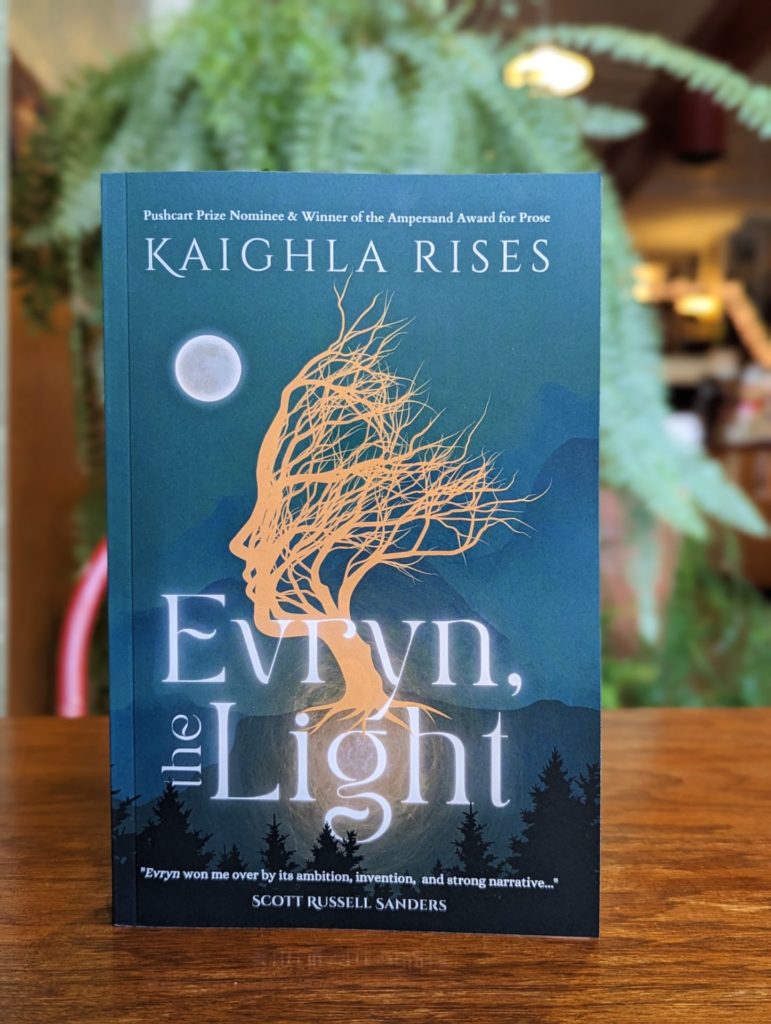 The cover of Evryn, the Light. The cover is turquoise and features an outline of the profile of a figure with tree branches extending as part of the head.