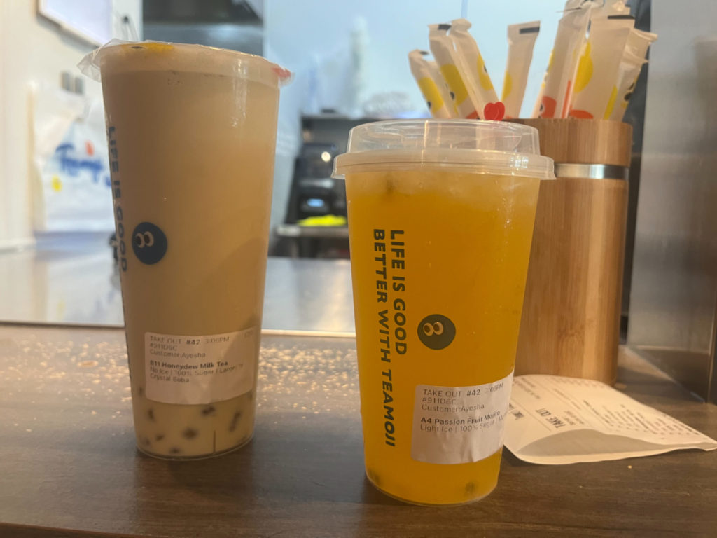 Two drinks from Teamoji: honeydew milk tea and passionfruit mojito. Photo by Ayesha Mehta.