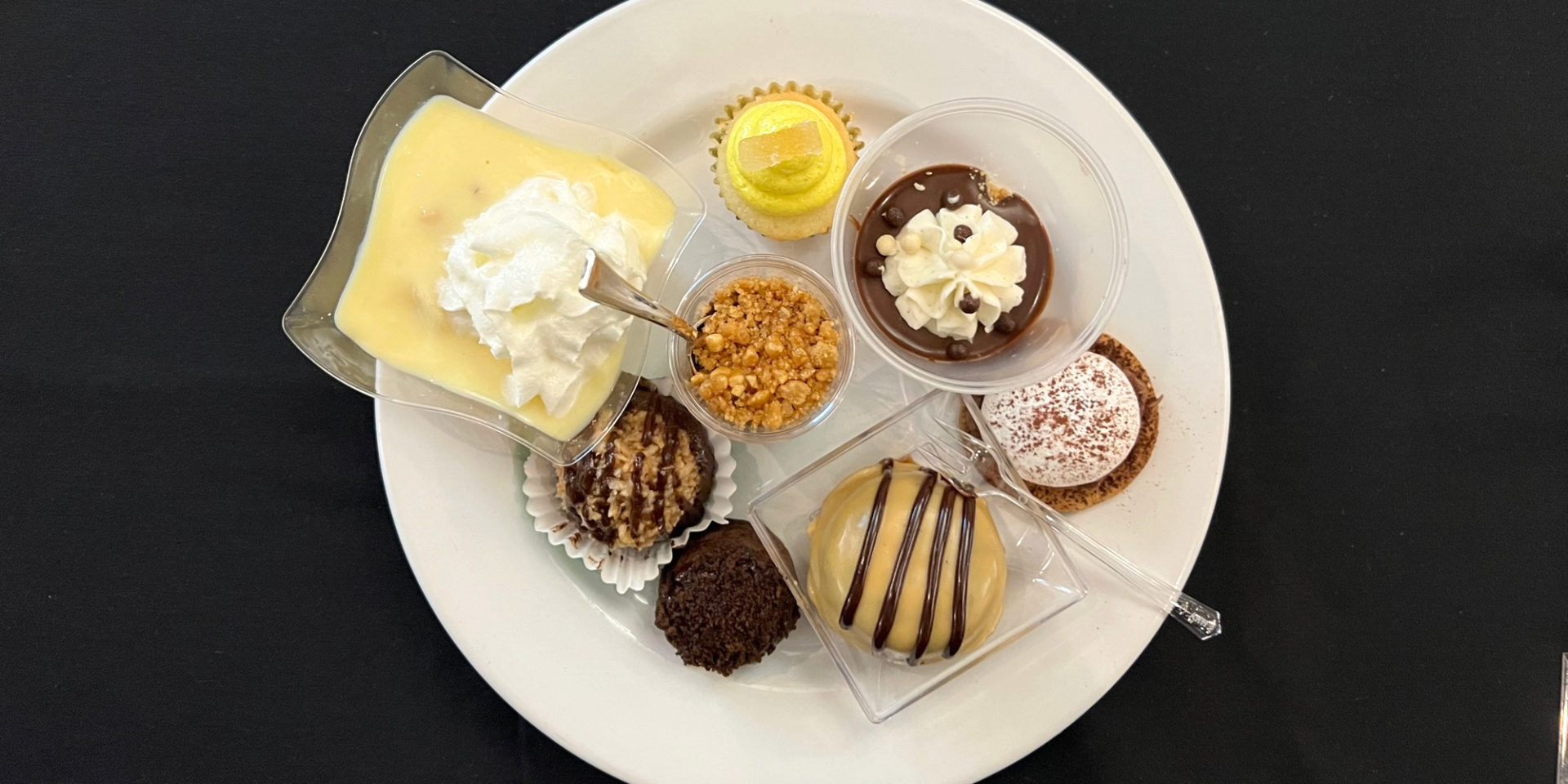 An overhead photo of the eight desserts for the 2023 Girl Scouts Diamonds, Desserts, and Distinction event in Champaign, Illinois. Photo by Alyssa Buckley.