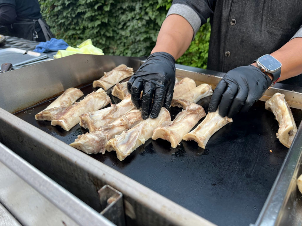 On the griddle, there are horizontally sliced bones being finished for the fourth course of the tequila tasting dinner. Photo by Alyssa Buckley.