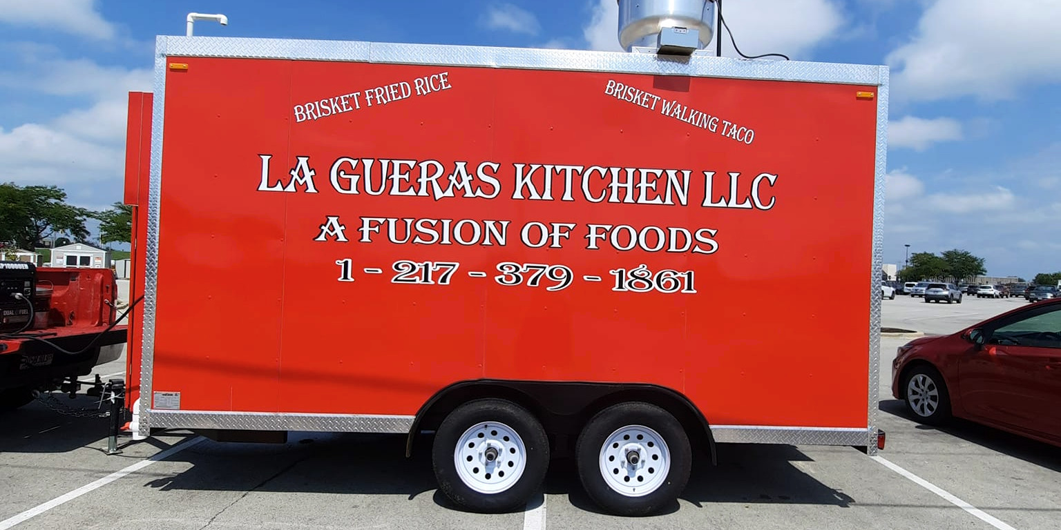 La Gueras Kitchen, the new food truck, is a red trailer with simple white font. Photo from La Gueras Kitchen on Facebook.