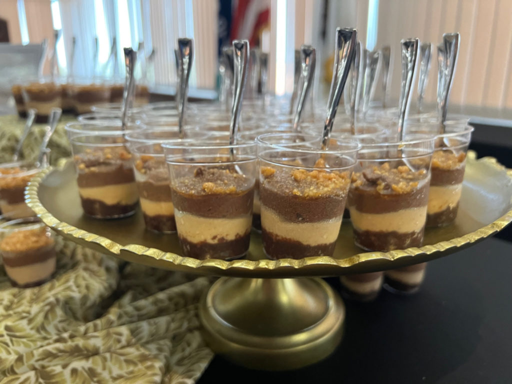 On a gold stand, there are little cups of layered desserts. Photo by Alyssa Buckley.