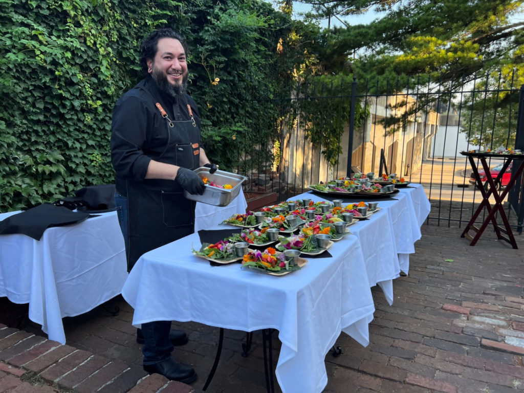 Outside, Adam Lopez of Maize Mexican Grill prepares the salad course for the tequila dinner on the patio of Maize at The Station. Photo by Alyssa Buckley.