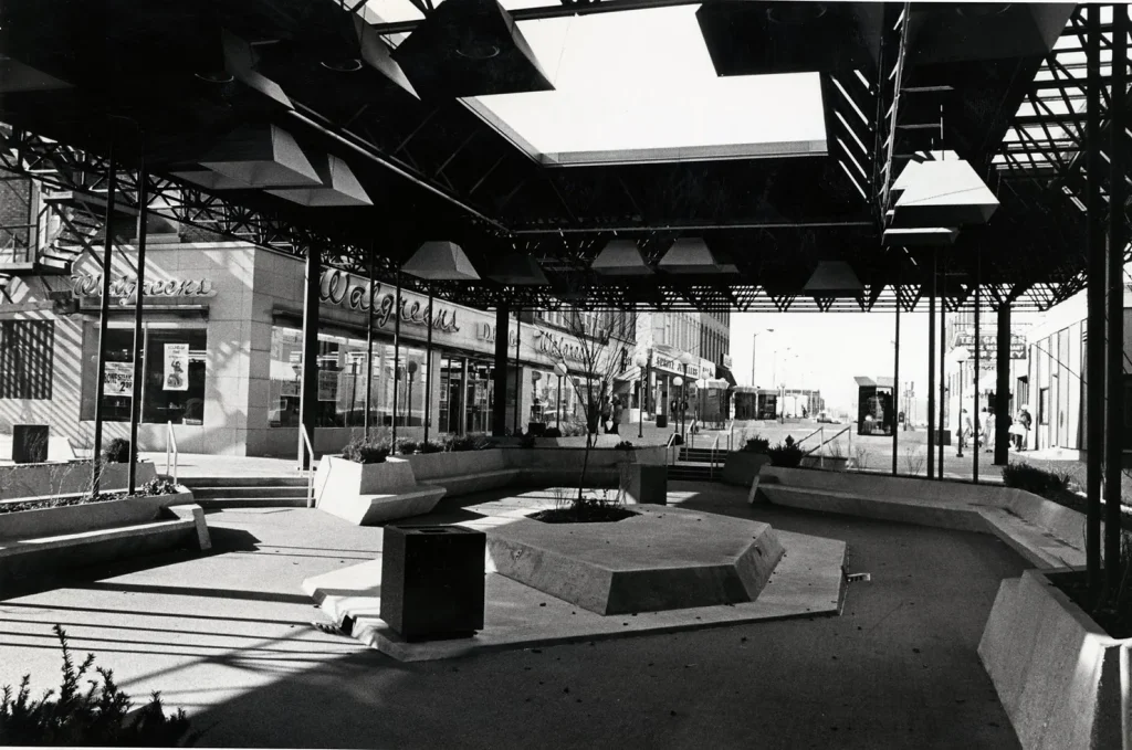 By 1976, Neil Street was closed to vehicles and this pavillion structure erected across the intersection of Taylor and Neil Streets. The mall would be moved in 1986. Photo credit to Champaign County Historical Archives at The Urbana Free Library.