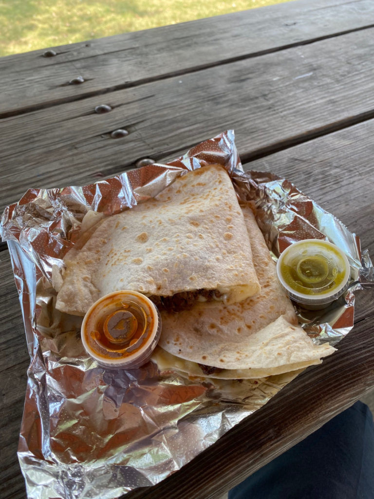 A sliced quesadilla with two cups of sauce. Photo by Mikey Hillyer.
