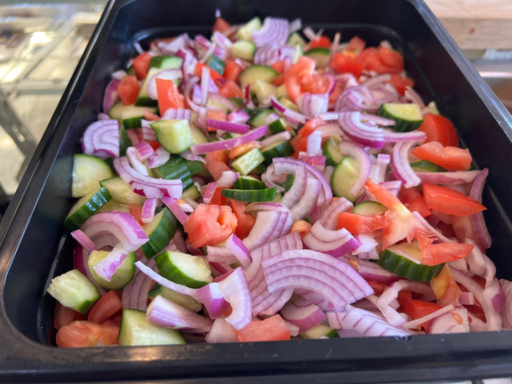 A large catering pan of Algerian salad at North African Cuisine restaurant. Photo by Alyssa Buckley.