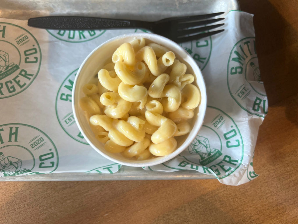 An overhead photo of macaroni in a paper cup with a plastic fork beside it. Photo by Alyssa Buckley.
