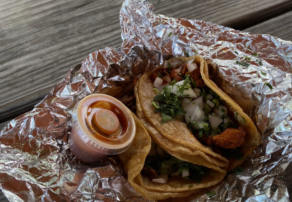 Two tacos in tin foil. Photo by Mikey Hillyer.