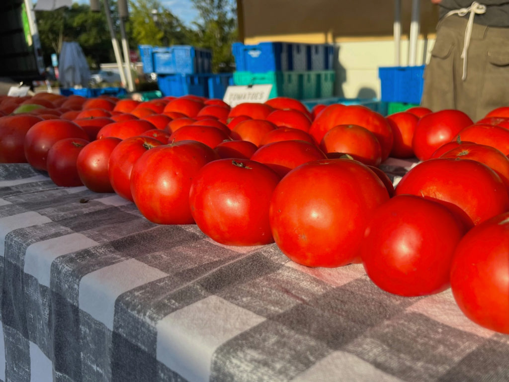 Bright red tomatoes for sale at the Champaign-Urbana farmers' market. Photo by Alyssa Buckley.
