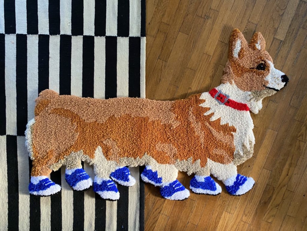 Corgipillar rug- a corgi with extra legs wear blue shoes on its feet