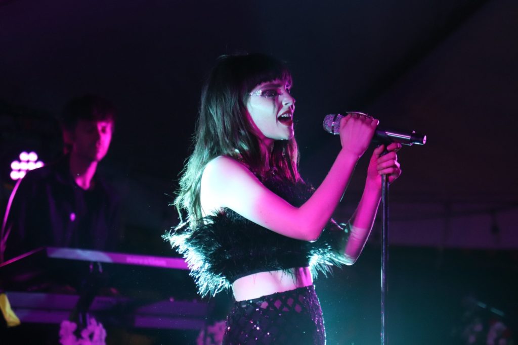 Lauren Mayberry singing into a microphone
