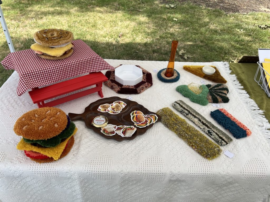 an assortment of high in fiber mini rugs and stickers are on a table, including a multistack of rugs that resemble a hamburger